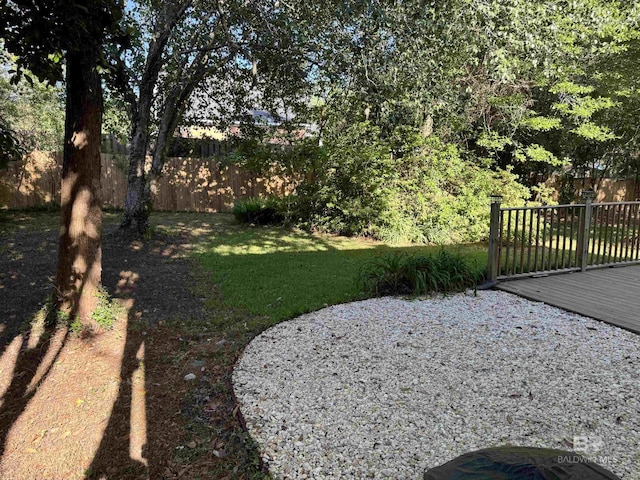 view of yard with fence and a wooden deck