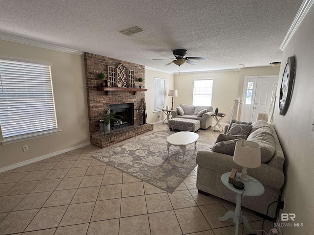 tiled living area with a brick fireplace, a textured ceiling, a ceiling fan, baseboards, and ornamental molding