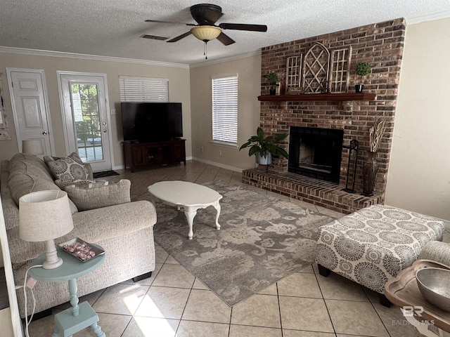 living area featuring crown molding, tile patterned floors, a textured ceiling, a ceiling fan, and visible vents