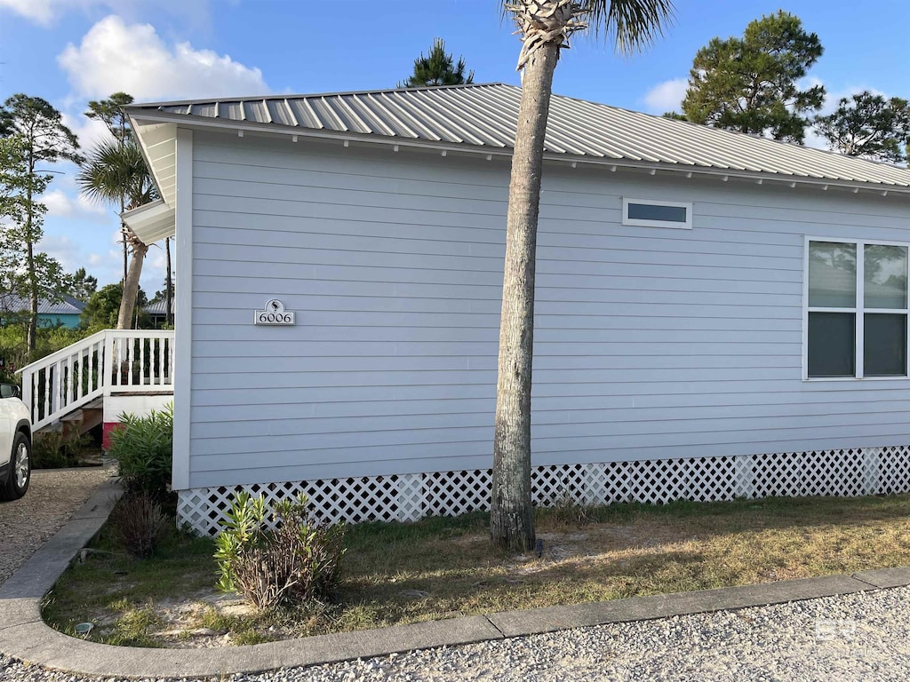 view of side of property featuring metal roof