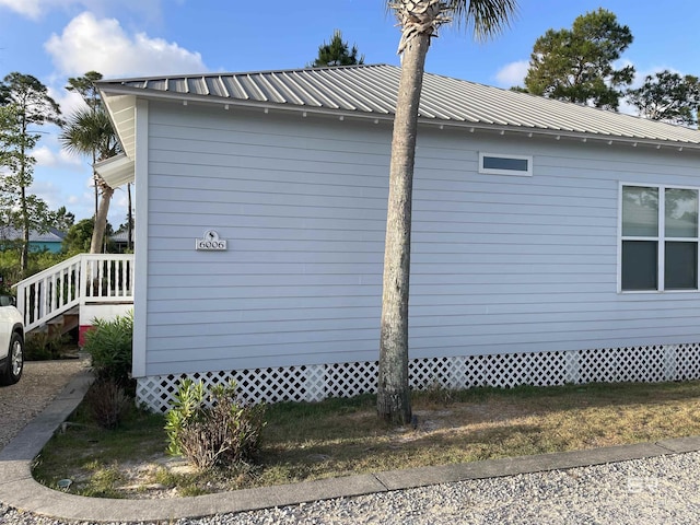 view of side of property featuring metal roof