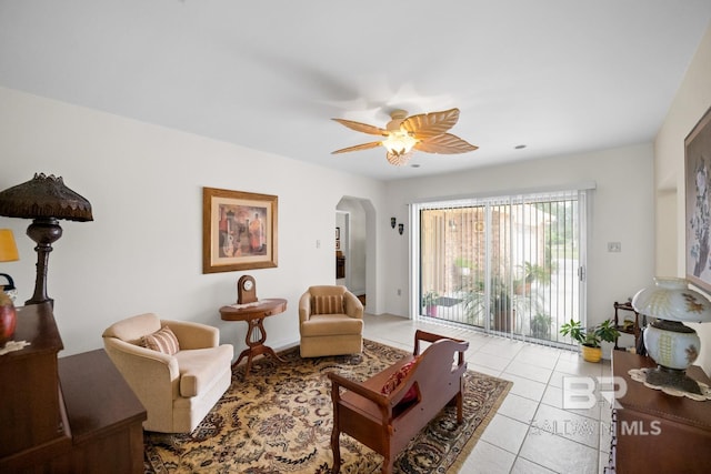 35788 Boykin Blvd, Lillian, AL 36549 - living room with arched walkways, ceiling fan, and light tile patterned floors