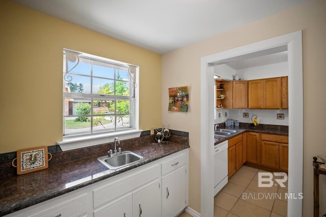 35788 Boykin Blvd, Lillian, AL 36549 - kitchen featuring white dishwasher, light tile patterned floors, a sink, and white cabinetry