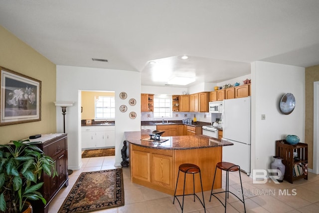 35788 Boykin Blvd, Lillian, AL 36549 - kitchen featuring white appliances, light tile patterned floors, open shelves, and a sink