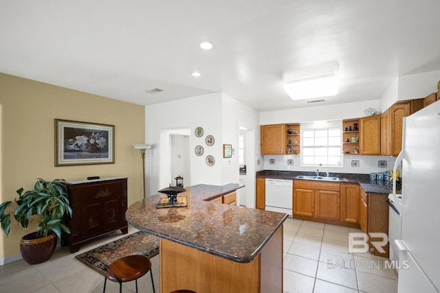35788 Boykin Blvd, Lillian, AL 36549 - kitchen with a kitchen island, open shelves, a sink, light tile patterned floors, and white appliances