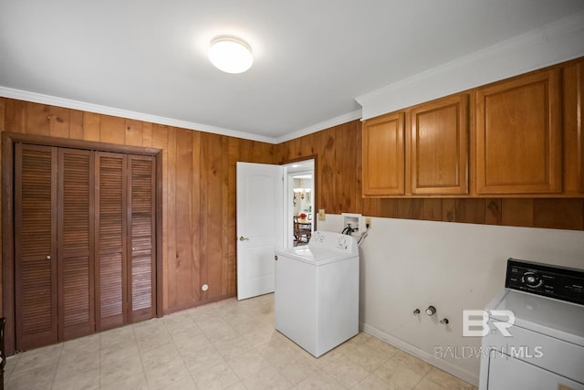 35788 Boykin Blvd, Lillian, AL 36549 - washroom with ornamental molding, baseboards, wooden walls, separate washer and dryer, and cabinet space