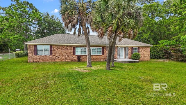 35788 Boykin Blvd, Lillian, AL 36549 - back of property featuring a lawn, roof with shingles, fence, and brick siding