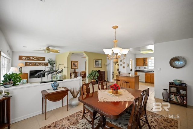 35788 Boykin Blvd, Lillian, AL 36549 - dining room with arched walkways, ceiling fan with notable chandelier, and light tile patterned floors