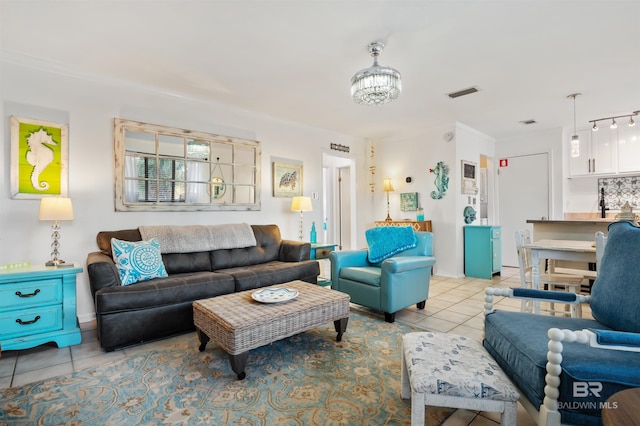 tiled living room featuring a notable chandelier