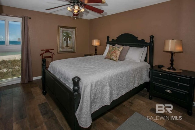 bedroom with ceiling fan and dark wood-type flooring