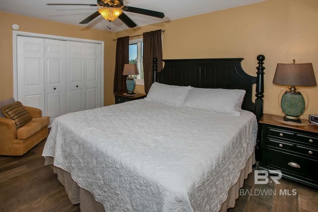 bedroom featuring ceiling fan, a closet, and dark wood-type flooring