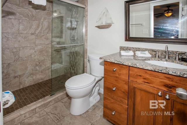 bathroom featuring vanity, ceiling fan, tile floors, a shower with door, and toilet