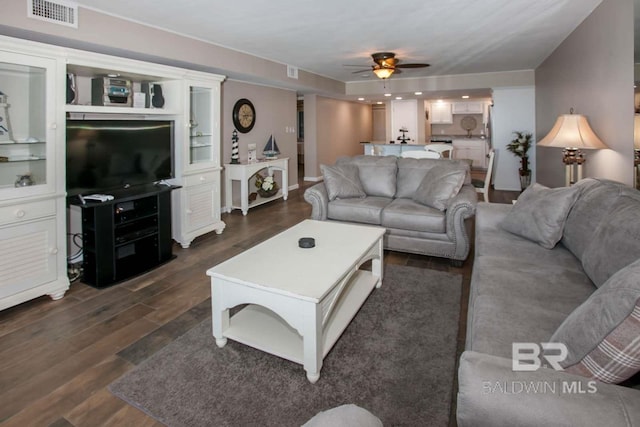 living room with dark hardwood / wood-style floors and ceiling fan