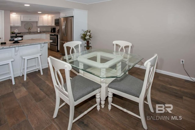 dining area featuring dark wood-type flooring