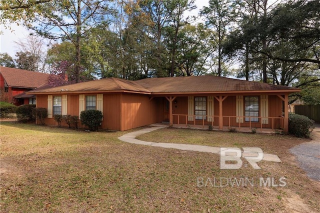 ranch-style house with a front lawn and covered porch