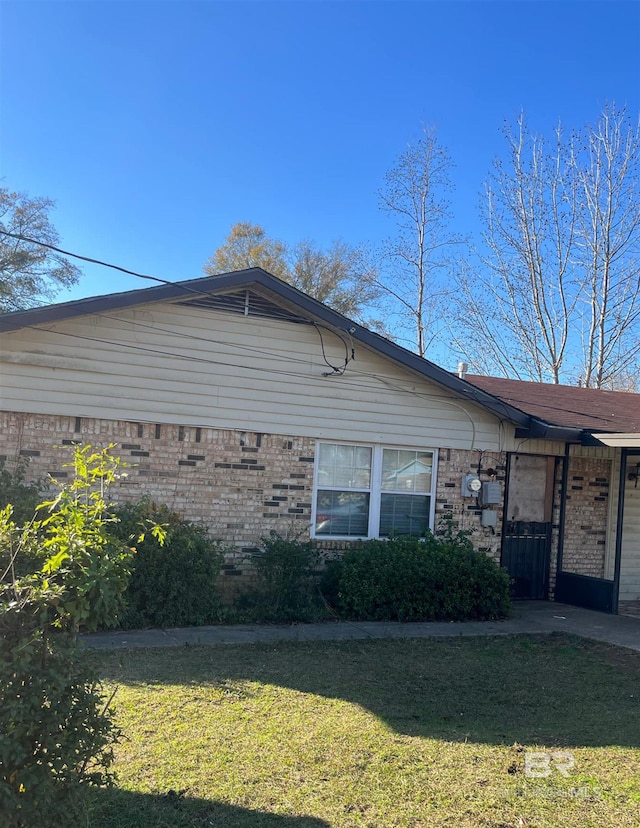 view of side of home featuring a yard