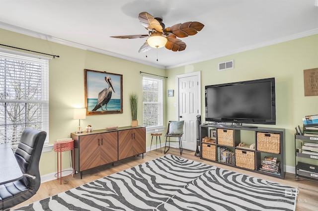 office space featuring visible vents, plenty of natural light, a ceiling fan, and crown molding