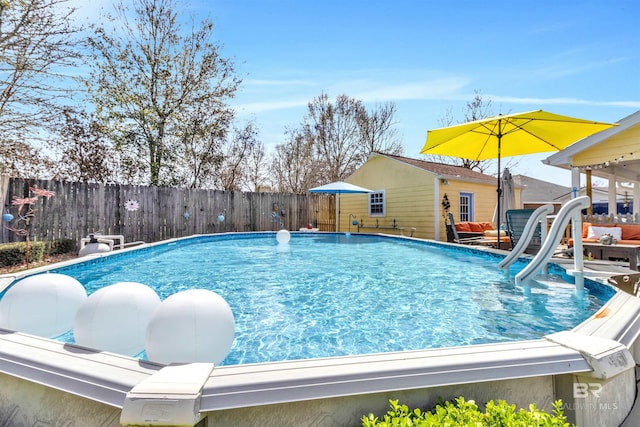 view of pool with a fenced in pool, a patio, and fence