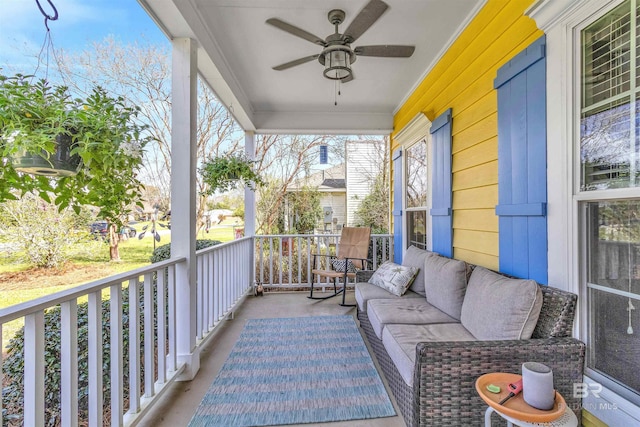 balcony featuring a porch, a ceiling fan, and an outdoor living space