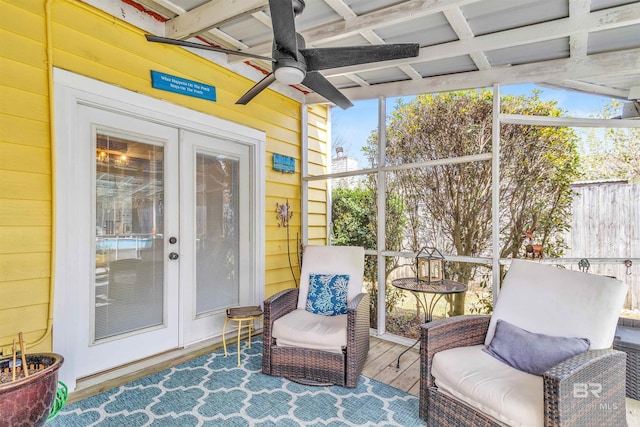 sunroom / solarium featuring ceiling fan