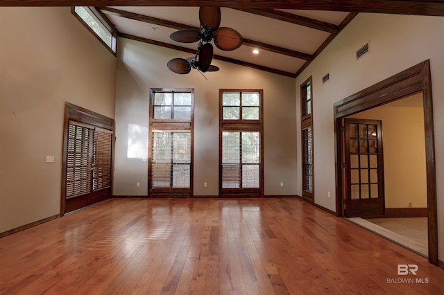 unfurnished room featuring beam ceiling, light wood-type flooring, high vaulted ceiling, and ceiling fan