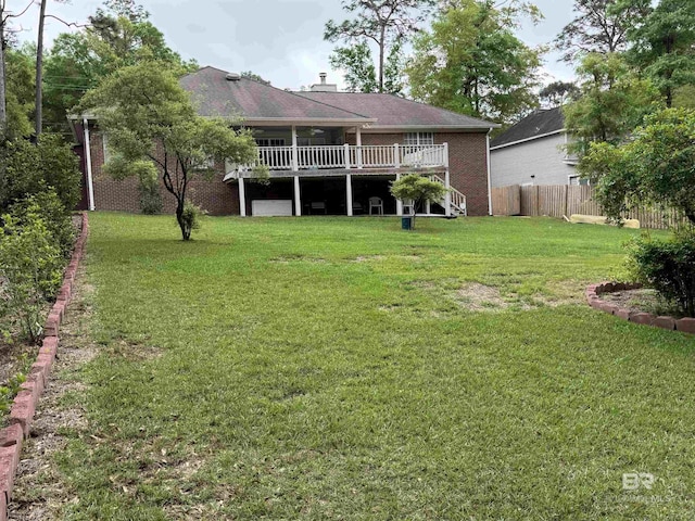 view of yard featuring fence and a deck