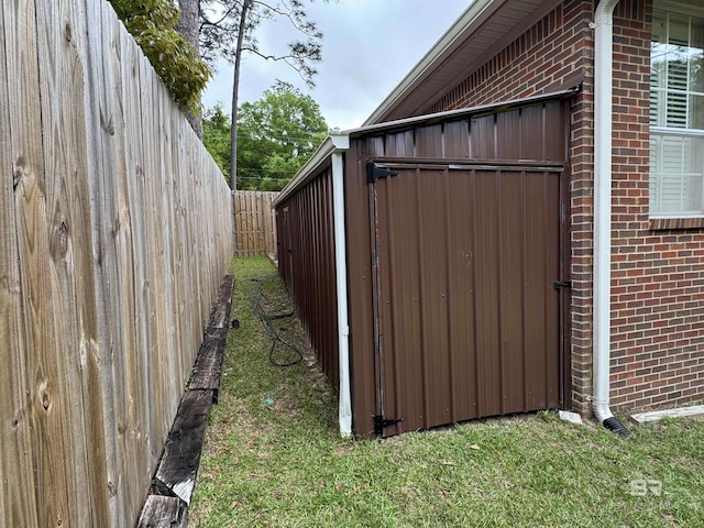 view of property exterior with fence and brick siding