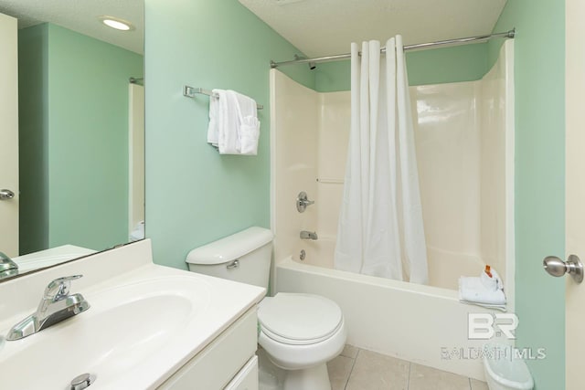 full bathroom featuring a textured ceiling, toilet, tile patterned floors, shower / bath combo with shower curtain, and vanity