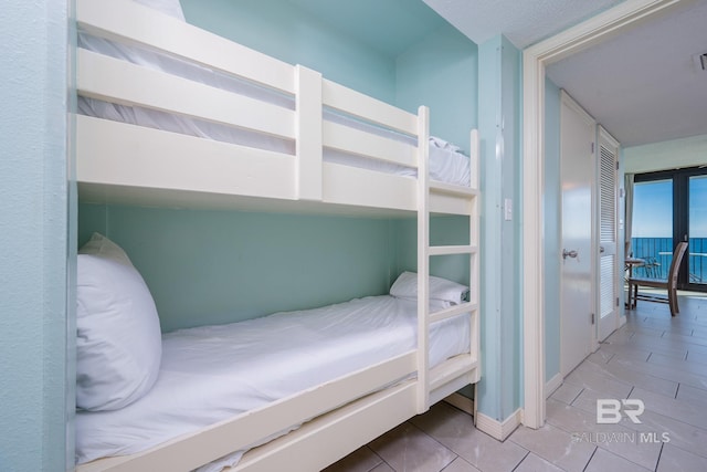 tiled bedroom with a closet