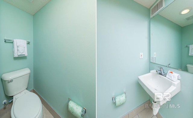 bathroom with toilet and tile patterned flooring