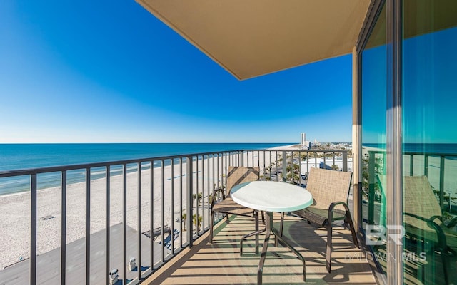 balcony with a beach view and a water view