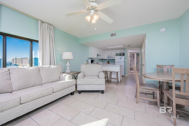 living room with light tile patterned flooring and ceiling fan