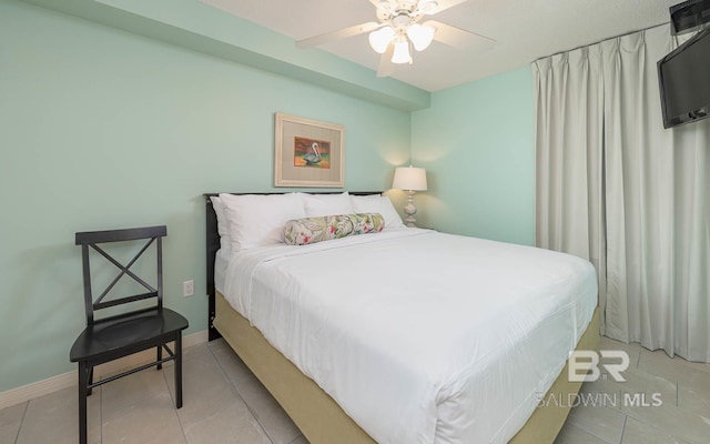 bedroom featuring ceiling fan and light tile patterned floors