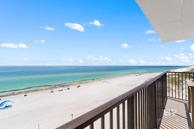 balcony featuring a water view and a view of the beach