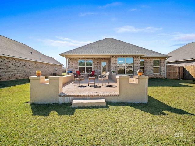 rear view of house featuring a yard and a patio area