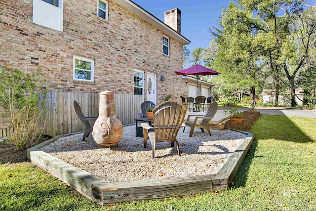 view of play area featuring a patio, fence, and a yard