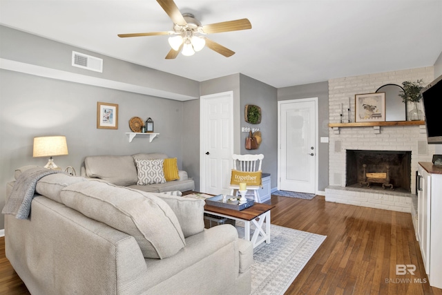 living area with visible vents, ceiling fan, dark wood-style flooring, and baseboards