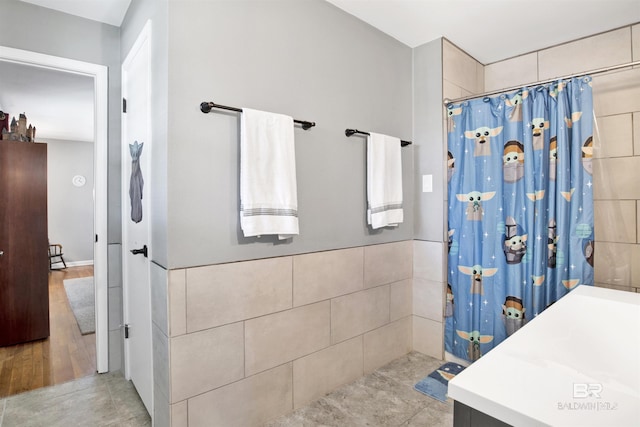 full bathroom featuring tile walls and a shower with curtain