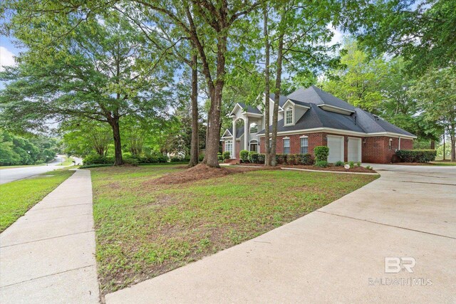 9330 Timbercreek Blvd, Daphne, AL 36527 - view of front of home featuring driveway, brick siding, a front lawn, and an attached garage