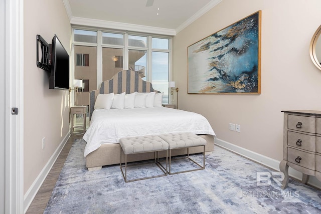 bedroom with crown molding, hardwood / wood-style floors, and ceiling fan