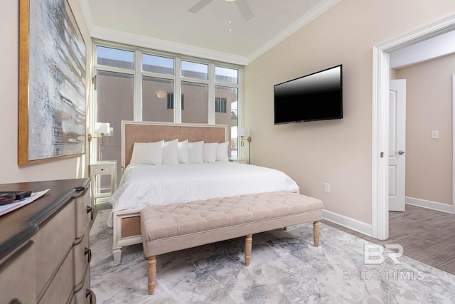 bedroom with ceiling fan, crown molding, and light hardwood / wood-style flooring