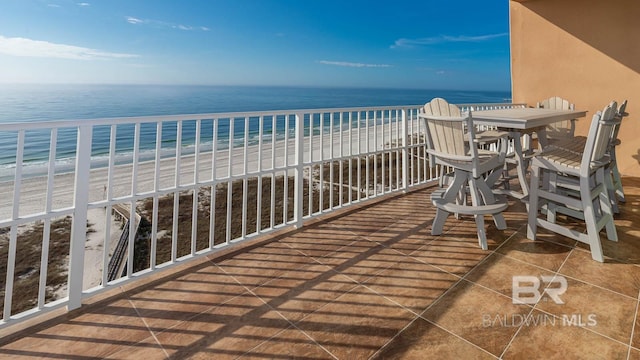 balcony with a beach view and a water view