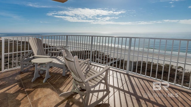 balcony with a view of the beach and a water view