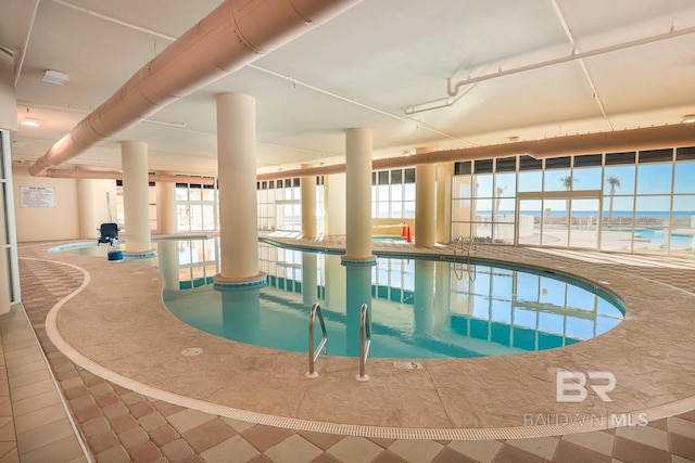 view of swimming pool featuring a water view