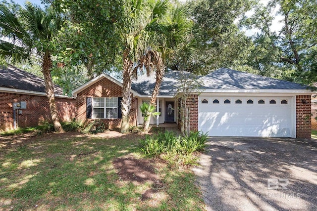 ranch-style house featuring a garage, driveway, roof with shingles, and brick siding