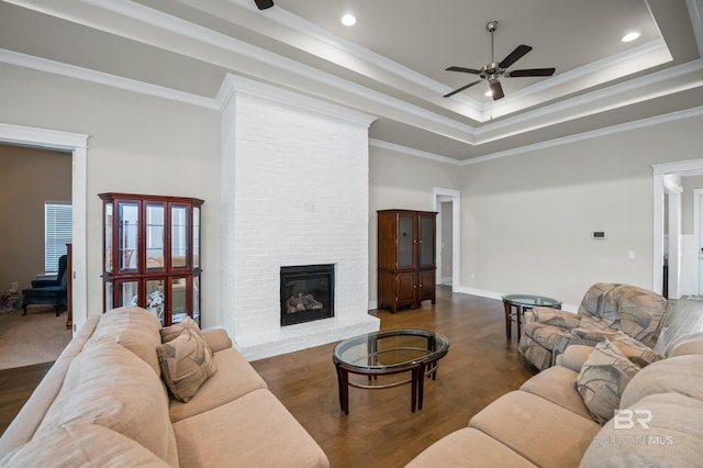 9377 Diamante Blvd, Daphne, AL 36526 - living area featuring ornamental molding, a tray ceiling, a ceiling fan, and wood finished floors