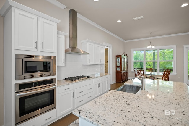 9377 Diamante Blvd, Daphne, AL 36526 - kitchen featuring wall chimney range hood, crown molding, backsplash, stainless steel appliances, and a sink