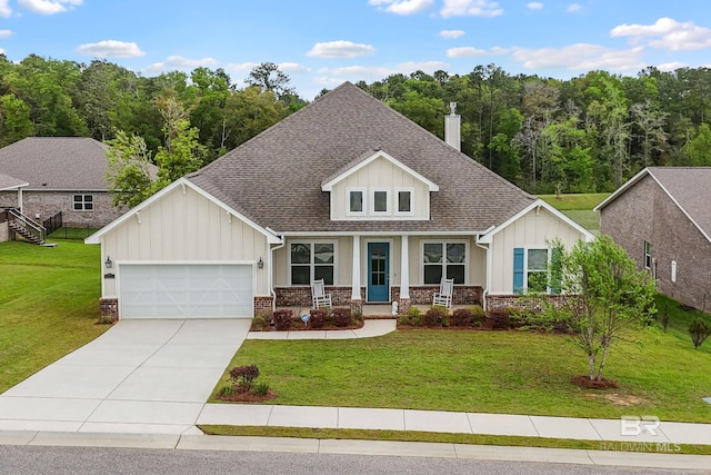 9377 Diamante Blvd, Daphne, AL 36526 - view of front of home with board and batten siding, a shingled roof, covered porch, and a garage
