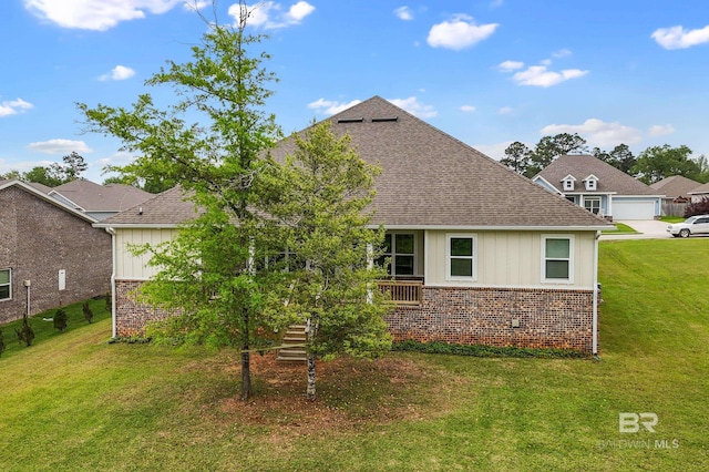 9377 Diamante Blvd, Daphne, AL 36526 - rear view of house featuring brick siding, a yard, board and batten siding, and roof with shingles