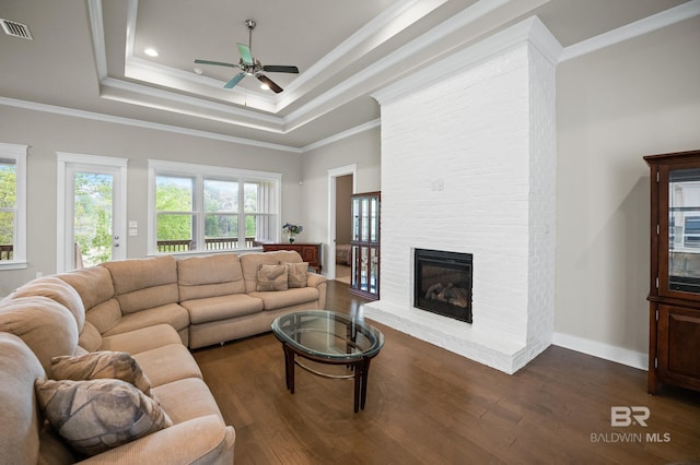 9377 Diamante Blvd, Daphne, AL 36526 - living room featuring ornamental molding, a raised ceiling, a ceiling fan, visible vents, and dark wood finished floors